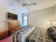 Bedroom with dresser, TV, and ceiling fan at 8015 Pequena Dr, Port Richey, FL 34668