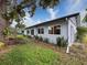 Newly renovated house exterior, featuring a gray color scheme and well-maintained landscaping at 8015 Pequena Dr, Port Richey, FL 34668