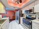Modern kitchen with stainless steel appliances and light cabinets at 8015 Pequena Dr, Port Richey, FL 34668