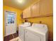 Laundry room with washer, dryer, and built-in cabinets at 8015 Pequena Dr, Port Richey, FL 34668