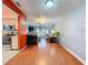 View of living room from kitchen, showing hardwood floor at 8015 Pequena Dr, Port Richey, FL 34668