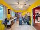 Bright sunroom with yellow walls, ceiling fan, and view of kitchen at 8015 Pequena Dr, Port Richey, FL 34668
