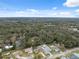 Aerial view showing a neighborhood with houses and surrounding landscape at 811 Laurelridge Ct, Brooksville, FL 34601