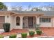 Front entry with wrought iron gate and landscaping at 8154 Giffen Ln, Spring Hill, FL 34608