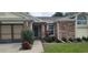 Brick home's entrance with well-maintained landscaping at 8213 Reynolds, Hudson, FL 34667