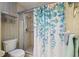 Bathroom featuring a glass shower stall, leafy shower curtain and towel rack at 10200 Casey Dr, New Port Richey, FL 34654