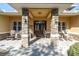 Covered front porch with stone columns and rocking chairs at 10901 Pinto Dr, Hudson, FL 34669