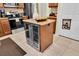 Kitchen island with wine cooler and granite countertop at 10901 Pinto Dr, Hudson, FL 34669