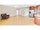 Bright living room with tile floors and a view into the kitchen at 11041 Paradise Point Way, New Port Richey, FL 34654