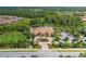 Aerial view of community clubhouse and pool with surrounding landscape at 11061 Egeria Dr, Odessa, FL 33556