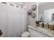 Clean bathroom with shower/tub combo, white vanity, and granite countertop at 11061 Egeria Dr, Odessa, FL 33556