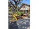 Landscaped entrance to a community building with trees and walkway at 11203 Pembridge Ct # 1, Port Richey, FL 34668