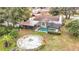 House with pool and backyard, featuring a circular fire pit area at 12529 Shadow Ridge Blvd, Hudson, FL 34669