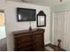 Bedroom featuring a dresser, TV, and large closet at 12529 Shadow Ridge Blvd, Hudson, FL 34669