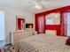 Red-walled bedroom with a bed, dresser, and TV at 12529 Shadow Ridge Blvd, Hudson, FL 34669