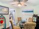 Dining room with glass table and beach themed art at 12529 Shadow Ridge Blvd, Hudson, FL 34669