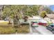 House exterior with a large yard and driveway, offering ample parking space at 12529 Shadow Ridge Blvd, Hudson, FL 34669