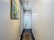 Bright hallway with dark wood floors leading to bathroom at 12529 Shadow Ridge Blvd, Hudson, FL 34669