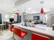 Kitchen with breakfast bar, red barstools, and stainless steel appliances at 12529 Shadow Ridge Blvd, Hudson, FL 34669