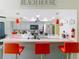 Kitchen boasts a breakfast bar with red stools and updated appliances at 12529 Shadow Ridge Blvd, Hudson, FL 34669