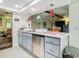 Kitchen with island, stainless steel dishwasher, and gray cabinets at 12529 Shadow Ridge Blvd, Hudson, FL 34669