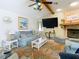 Bright living room features a fireplace, comfy seating, and large TV at 12529 Shadow Ridge Blvd, Hudson, FL 34669