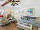 Living room with light blue sofas, a coffee table, and beach-themed decor at 12529 Shadow Ridge Blvd, Hudson, FL 34669
