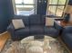 Cozy living room with a blue sofa and glass-top coffee table at 12529 Shadow Ridge Blvd, Hudson, FL 34669