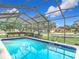 Screened pool with patio furniture and backyard views at 12529 Shadow Ridge Blvd, Hudson, FL 34669