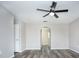 Bedroom with ceiling fan, wood-look floors, and archway at 1302 Dragon Head Dr, Valrico, FL 33594