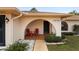 Covered entryway with red chairs and landscaping at 13058 Santee St, Spring Hill, FL 34609