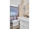 Clean bathroom with a toilet, vanity, and shower at 1333 Normandy Blvd, Holiday, FL 34691