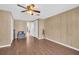 Simple bedroom with wood-look floors and ceiling fan at 1333 Normandy Blvd, Holiday, FL 34691