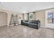 Living room with grey sectional and tiled floor at 1333 Normandy Blvd, Holiday, FL 34691