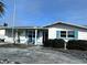 One-story house with white walls, blue shutters, and a driveway at 13612 Veronica Dr, Hudson, FL 34667