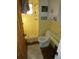 Bright yellow tiled bathroom with shower and toilet at 13618 Stacey Dr, Hudson, FL 34667
