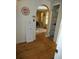 Bright hallway with hardwood floors and access to other rooms at 13618 Stacey Dr, Hudson, FL 34667