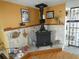 Cozy living space with a unique wood-burning stove and stone accent wall feature at 13618 Stacey Dr, Hudson, FL 34667