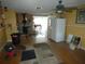 Spacious living area with hardwood floors, a wood-burning stove, and a view into the kitchen at 13618 Stacey Dr, Hudson, FL 34667