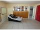 Neutral living room featuring unique partition shelving and tile flooring at 13618 Stacey Dr, Hudson, FL 34667