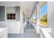 Long covered porch with ceiling fans and white railings at 14325 Highgrove Rd, Brooksville, FL 34609