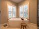 Bathroom with soaking tub, walk-in shower, and natural light at 18025 Nimick Rd, Weeki Wachee, FL 34614