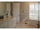 Bright bathroom with double vanity, soaking tub, and large window at 18025 Nimick Rd, Weeki Wachee, FL 34614
