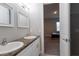 Clean bathroom with double sinks and a view into a bedroom at 18025 Nimick Rd, Weeki Wachee, FL 34614