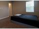 Simple bedroom with a dark-colored comforter and an ensuite bathroom at 18025 Nimick Rd, Weeki Wachee, FL 34614