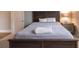 Bedroom with a bed, nightstand, and door at 18025 Nimick Rd, Weeki Wachee, FL 34614