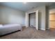 Simple bedroom with gray carpet and a walk-in closet at 18025 Nimick Rd, Weeki Wachee, FL 34614
