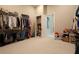Walk-in closet with custom shelving and hanging rods at 18025 Nimick Rd, Weeki Wachee, FL 34614