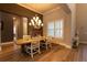 Elegant dining room with a large wooden table and chandelier at 18025 Nimick Rd, Weeki Wachee, FL 34614