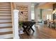 Bright entryway with foosball table, hardwood floors, and stairs at 18025 Nimick Rd, Weeki Wachee, FL 34614